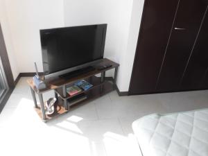 a flat screen tv on a stand in a room at lineweb Home sapporo803 in Sapporo