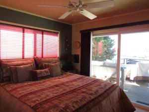 a bedroom with a bed and a ceiling fan at Smith Lakefront Hideaway in Big Bear Lake