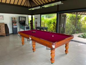 a pool table in the middle of a room at Private Island Stay in Vitouara