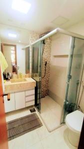 ein Bad mit einer Dusche, einem Waschbecken und einem WC in der Unterkunft Apartamento SQN 407 in Brasilia