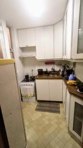 a kitchen with white cabinets and a sink at Apartamento SQN 407 in Brasilia