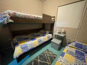 a bedroom with two bunk beds and a rug at Patagonia Dream’s in Puerto Montt