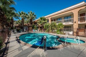 a swimming pool in front of a building at Quality Inn Saint George South Bluff in St. George