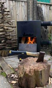 a wood fired oven with a fire in it at AppleTree Barn - Pembrokeshire Coast National Park in Pembroke