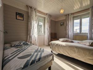 a bedroom with two beds and a window at Gîte spacieux en ancienne ferme rénovée, idéal pour familles et amis – proche randos et sites touristiques - FR-1-589-6 in Ban-sur-Meurthe-Clefcy
