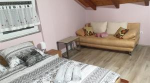 a bedroom with a bed and a couch at Family friendly house with a swimming pool Marija Bistrica, Zagorje - 21735 in Marija Bistrica