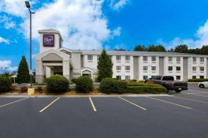 a large building with a parking lot in front of it at Sleep Inn in Lithonia