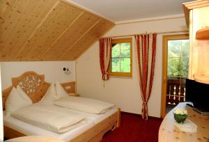 Letto o letti in una camera di Sagritzerwirt