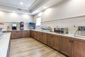 a large kitchen with wooden cabinets and appliances at MainStay Suites Ocean City West in Ocean City