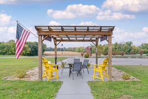 a gazebo with chairs and an american flag at Clarion Pointe in Jasper