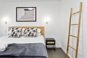 a bedroom with two beds and a ladder at 212 Boho Chic in Perth