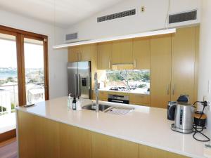 a kitchen with a sink and a counter top at Clovelly Beach House with Pool in Sydney