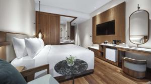a hotel room with a bed and a bathroom at Holiday Inn Resort Bali Canggu by IHG in Canggu