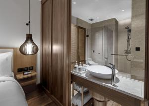 a bathroom with a sink and a shower at Holiday Inn Resort Bali Canggu by IHG in Canggu