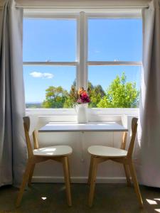 a table and two chairs in front of a window at Sassafras Springs in Ellendale