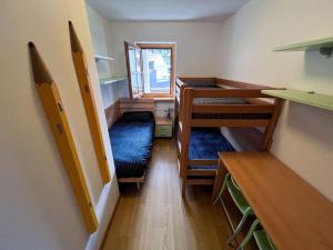 a small room with three bunk beds in it at Civico 11 in Tarvisio
