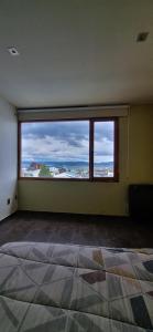 an empty room with a large window with a view at CASA COMPLETA 2 PLANTAS CON EXTRAORDINARIA VISTA AL CANAL BEAGLE CENTRICA 4pax in Ushuaia