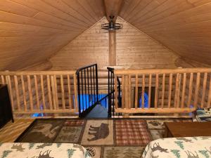 a room in a tent with a bed and a staircase at The Chena Valley Cabin, perfect for aurora viewing in Pleasant Valley