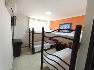 a room with two bunk beds and a window at HOTEL AVANTY INN in Barranquilla