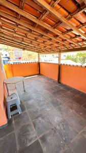 an empty patio with a table and a stool at Casa de Praia in Arraial do Cabo