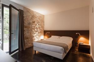 a bedroom with a large bed and a large window at Villa Boscarino in Ragusa
