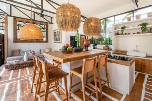 a kitchen with a table and chairs in a room at Yogi Surf Villas Complex Canggu in Canggu