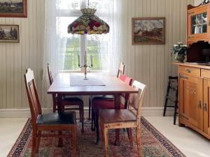 Holiday home NYE في Nye: غرفة طعام مع طاولة وكراسي خشبية