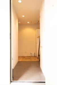 a hallway with a door open to a room at RIVER CENTRAL HIROSHIMA in Hiroshima