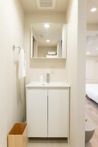 a bathroom with a white sink and a mirror at RIVER CENTRAL HIROSHIMA in Hiroshima