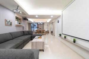 a living room with a couch and a coffee table at 3B2b Warm Cinema Home 4 Min to Xinyi Anhe MRT 三房二衛 投影機 4分到信義安和站 in Taipei