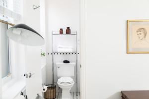a bathroom with a white toilet and a sink at Sleepover No 107 in Philadelphia