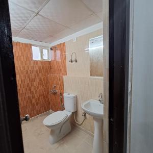 y baño con aseo y lavamanos. en Gokul 3BHK Service Apartment Bharat City Ghaziabad near Hindon Airport en Ghaziabad