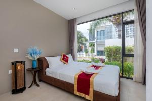 Postel nebo postele na pokoji v ubytování Sát Biển D6 + 27 fotografií