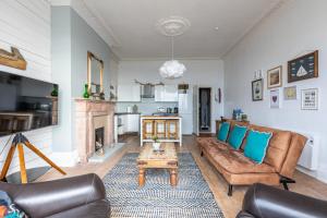 a living room with a couch and a table at Beach Lookout - SEA VIEWS in Lytham St Annes