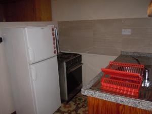 a kitchen with a white refrigerator and an oven at Number 20 in Birgu