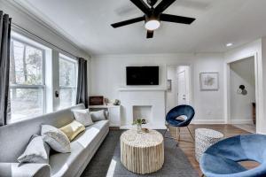 a living room with a couch and a tv at New Home in MidTown- Sleeps 11 For Rent in Atlanta in Atlanta