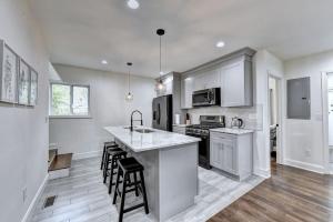 a kitchen with white cabinets and a counter top at New Home in MidTown- Sleeps 11 For Rent in Atlanta in Atlanta