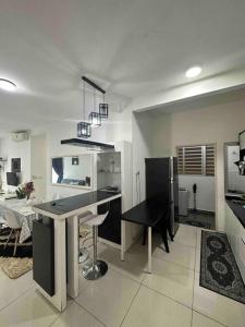 a kitchen with a table and a dining room at Family friendly apartment @Southville City in Kampong Tangkas