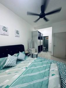 a bedroom with a bed with a ceiling fan at Family friendly apartment @Southville City in Kampong Tangkas