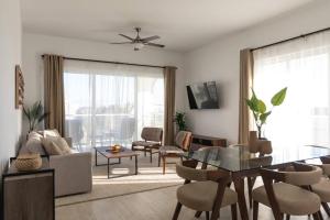 a living room with a couch and a table at Modern & relaxing penthouse Lake and Golf View in Punta Cana