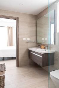 a bathroom with a tub and a sink and a mirror at Modern & relaxing penthouse Lake and Golf View in Punta Cana