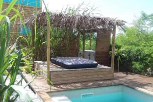 a blue inflatable bed sitting next to a pool at LE SUNSET gîte côté canne in Grand-Bourg