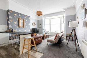 a living room with a table and a chair at Beach Shore - SEA VIEWS in Lytham St Annes