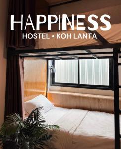 um cartaz para a felicidade hostel kotiki lantana com uma cama em em Happiness Hostel em Phra Ae beach