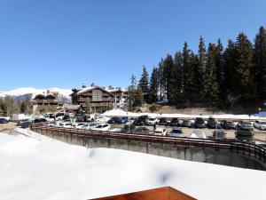 a bridge with cars parked in a parking lot at Appartement cosy avec skis aux pieds, parfait pour 4 personnes - Courchevel 1850 - FR-1-575-58 in Courchevel