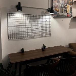 a table and chairs in a room with a window at Happiness Hostel in Phra Ae beach