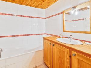 a bathroom with a sink and a bath tub at Charmant 3 pièces avec balcon, piscine et poêle à bois, proche des pistes à Serre Chevalier-Chantemerle - FR-1-762-26 in Saint-Chaffrey +7 photos