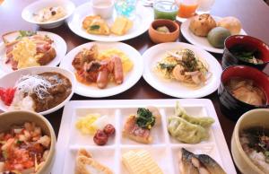 uma mesa cheia de pratos de comida numa mesa em KOKO HOTEL Sendai Station West em Sendai