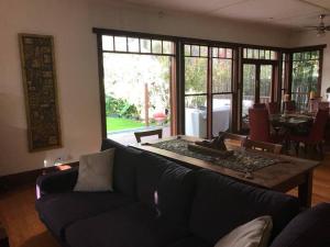 a living room with a couch and a table at Contemporary & Elegant 1920's Period House by My Lodgingfy International in Mentone