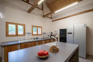 a kitchen with a white refrigerator and fruit on a counter at South of Shushan - On the left bank in Changning